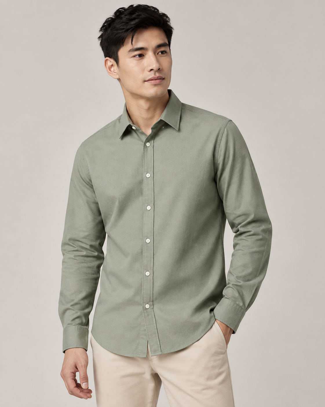Studio model wearing a sage-green Jacky & Jamey Oxford shirt